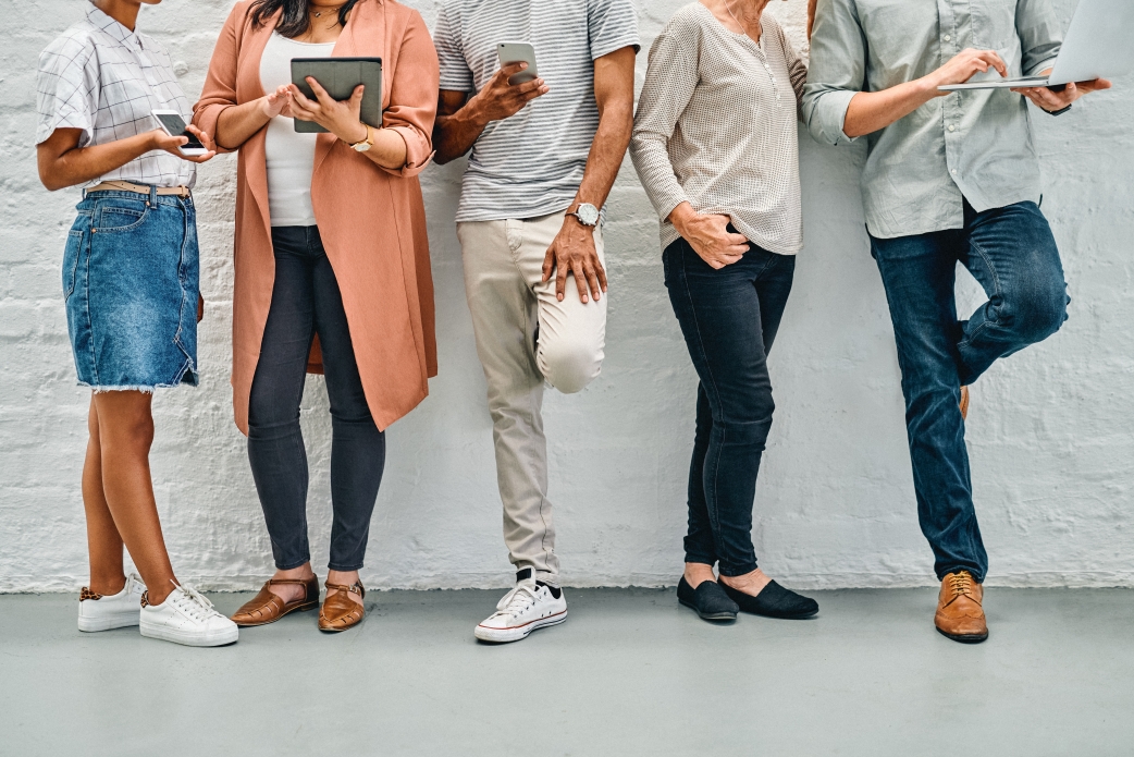 people standing up against a wall